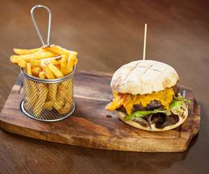 bruger and fries on a cutting board